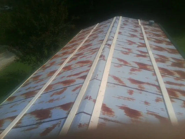 Rusted metal roof panels with new wood purlins before replacement — Storm Damage Roof Repair in Slate Run by Roofing Brothers