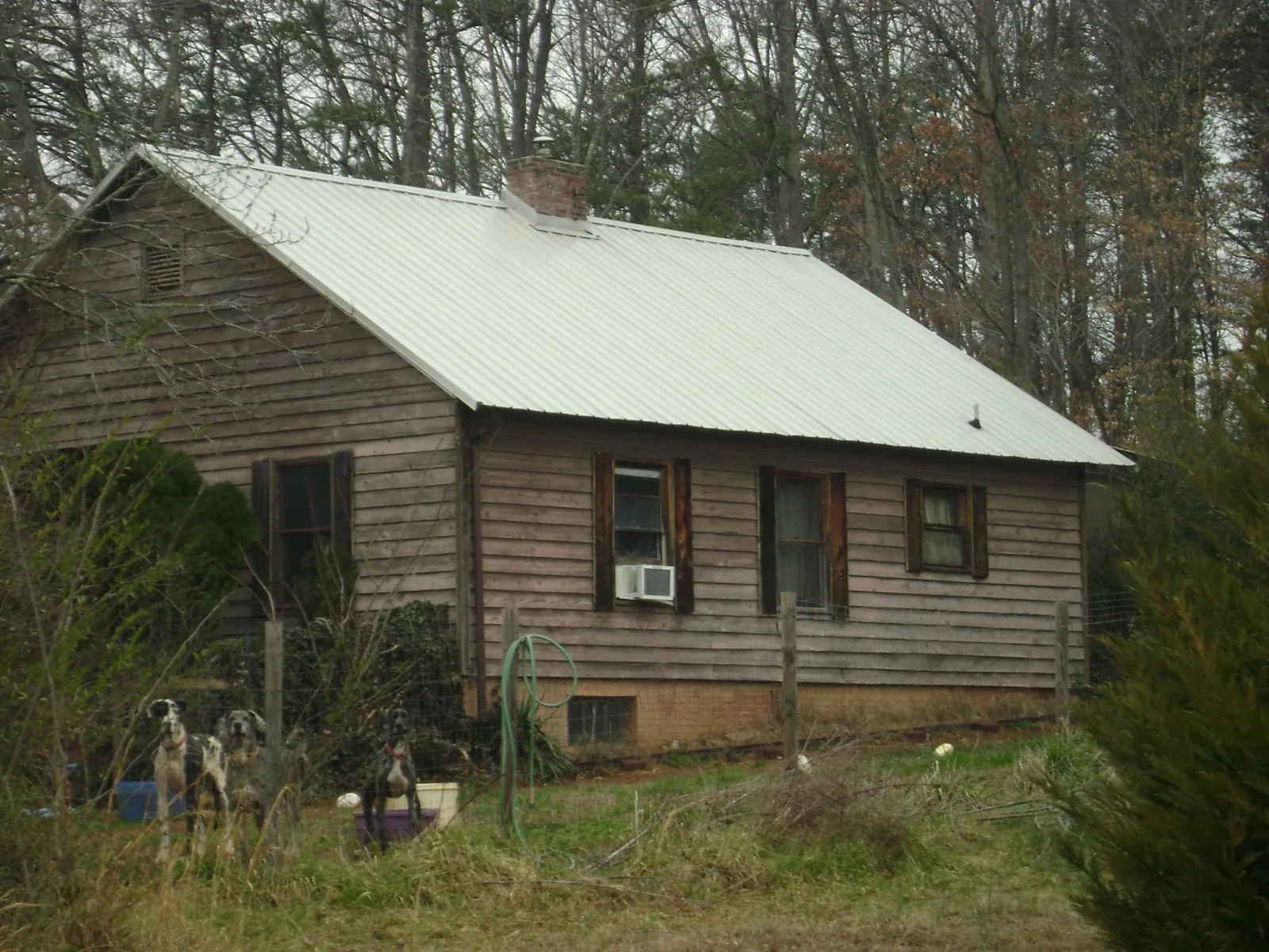 White metal roof on an old wood sided farmhouse, from a Metal Roof Installation job in Slate Run