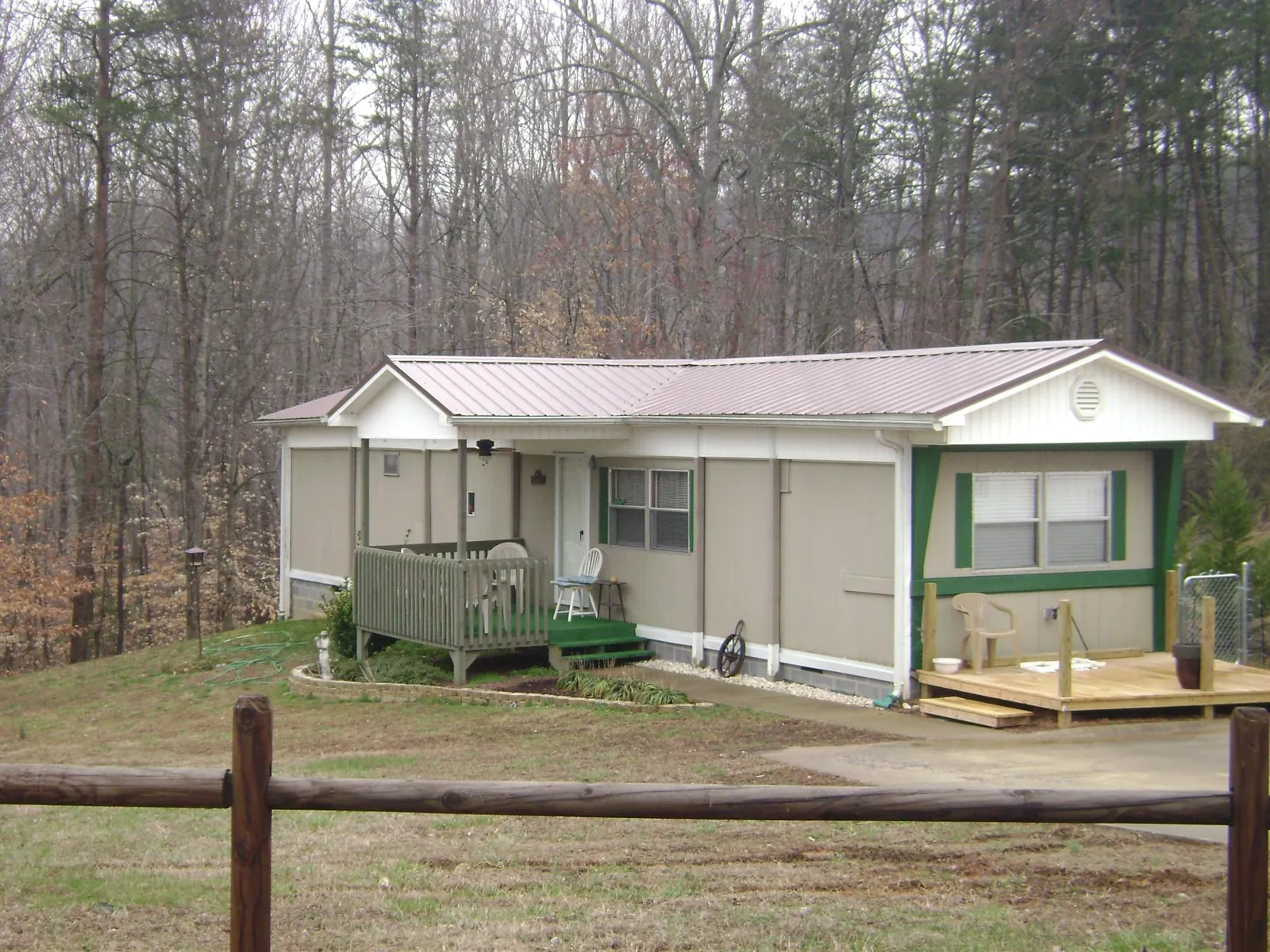 Mauve metal roof on a manufactured home with a new front deck in Slate Run